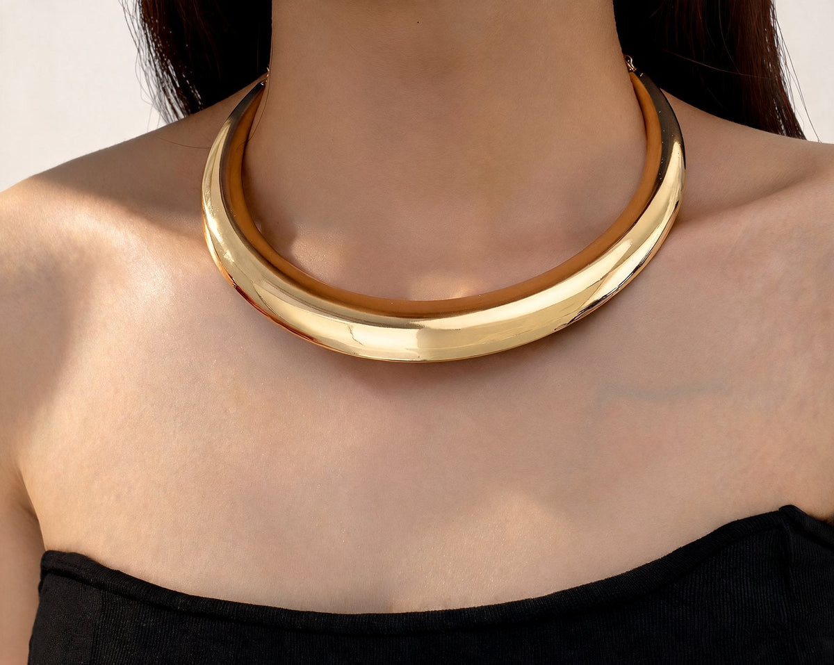 The Arc Collar in gold, worn