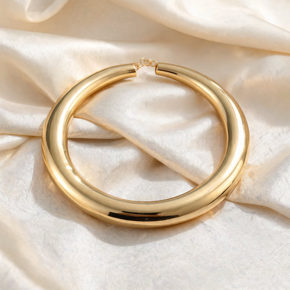 The Arc Collar in gold on ivory silk