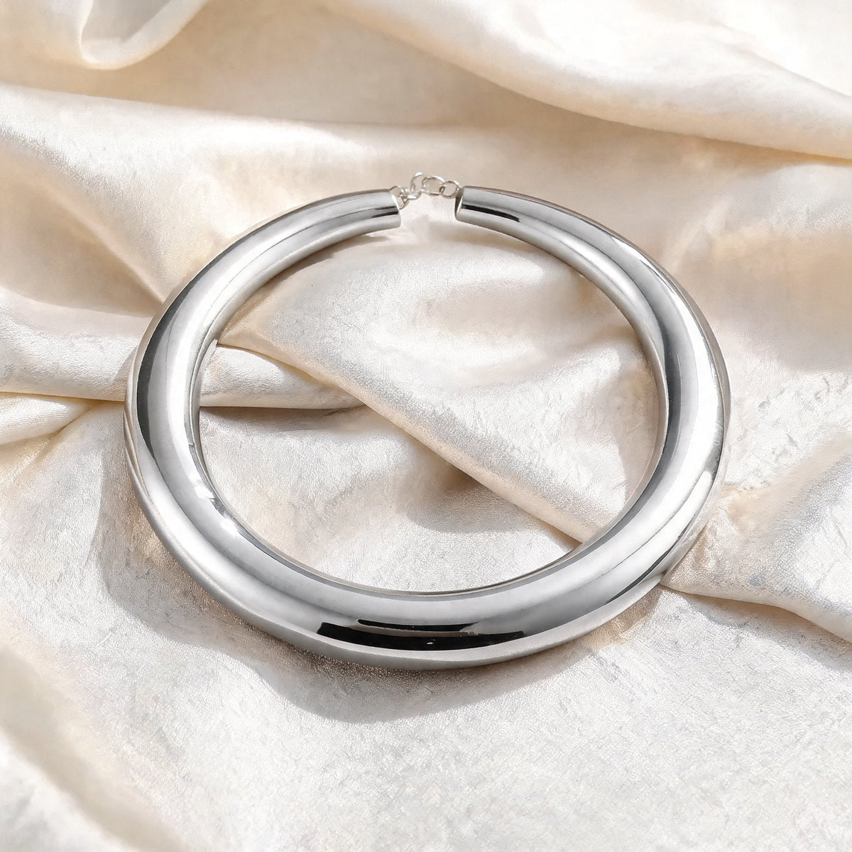 The Arc Collar in silver on ivory silk