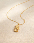 The Molten Pendant in gold, a hammered molten-look pendant on a fine gold chain