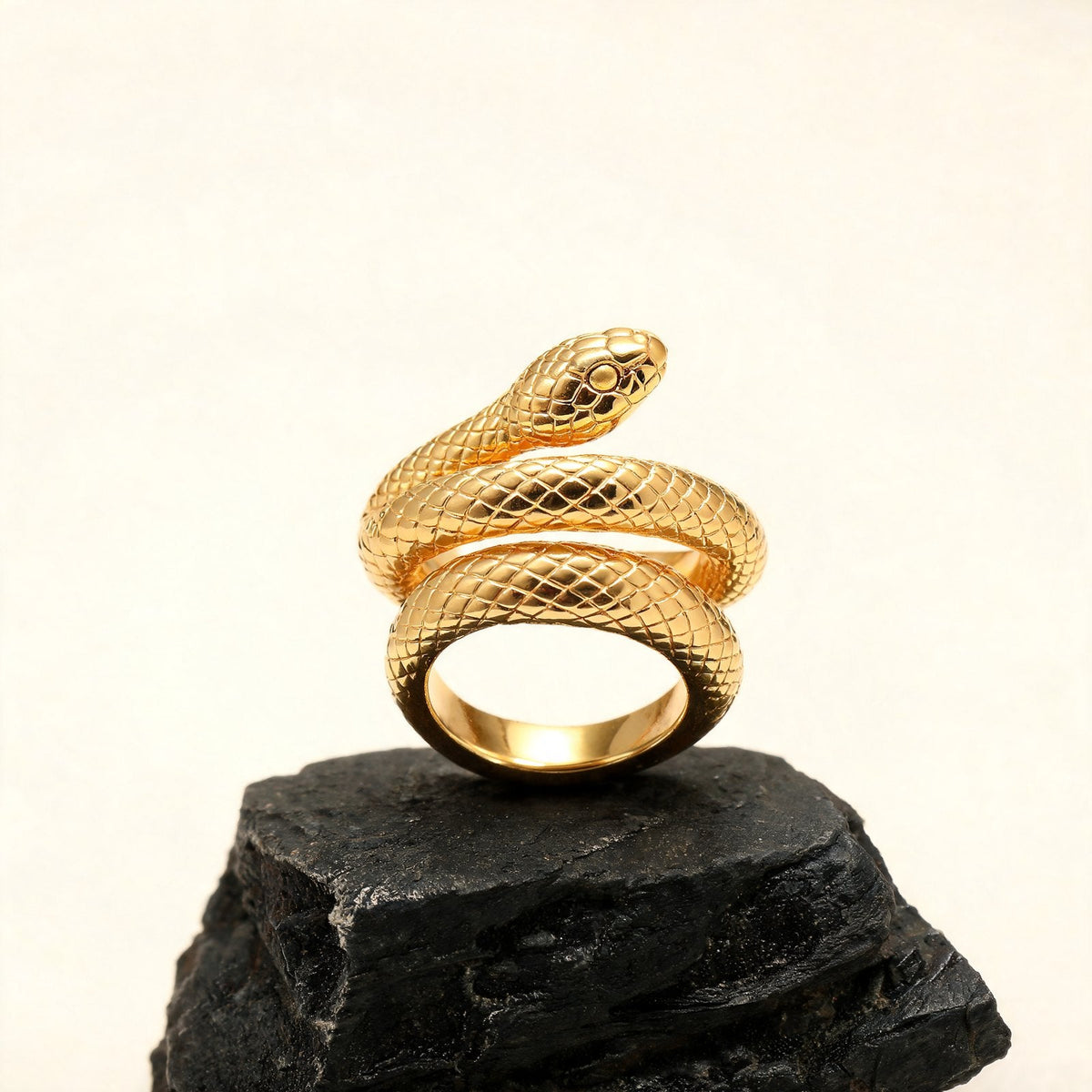 The Coil Ring in gold on black stone